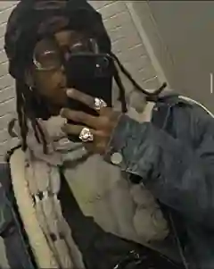 Candid mirror selfie of Prince Jona in a dark beanie, glasses, denim jacket and scarf
